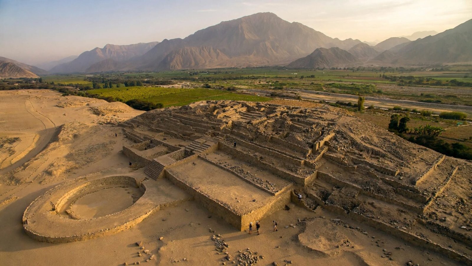 Aerial view of the ancient stone pyramids and circular plaza of Caral in Peru’s Supe Valley at sunset